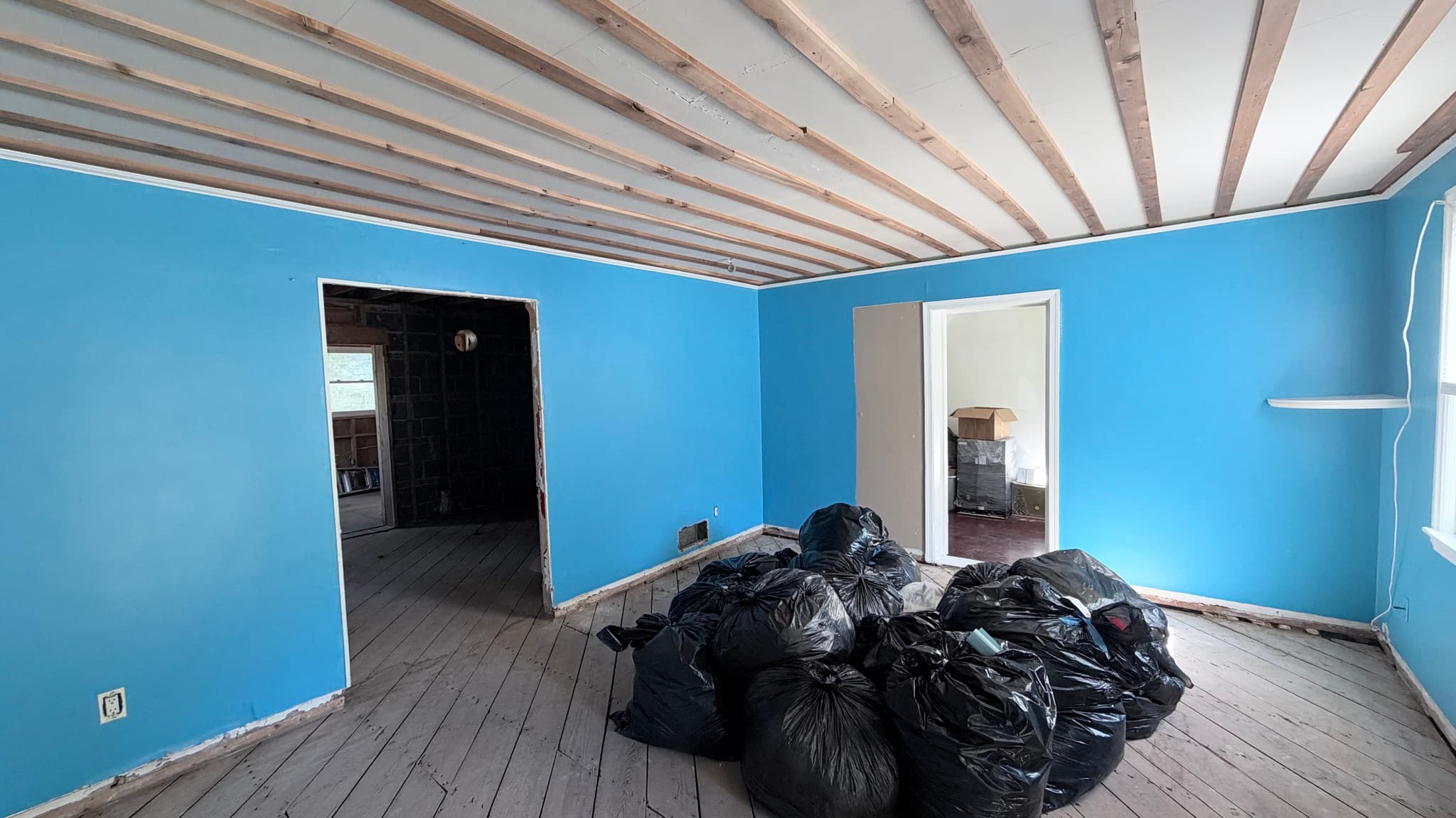 Main-level front room, ceiling opened up, doorways to the rest of the house