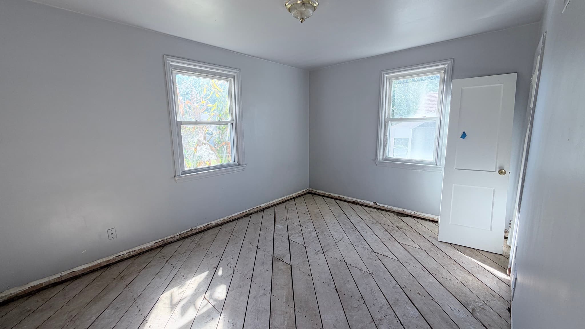 Main-level bedroom with two windows