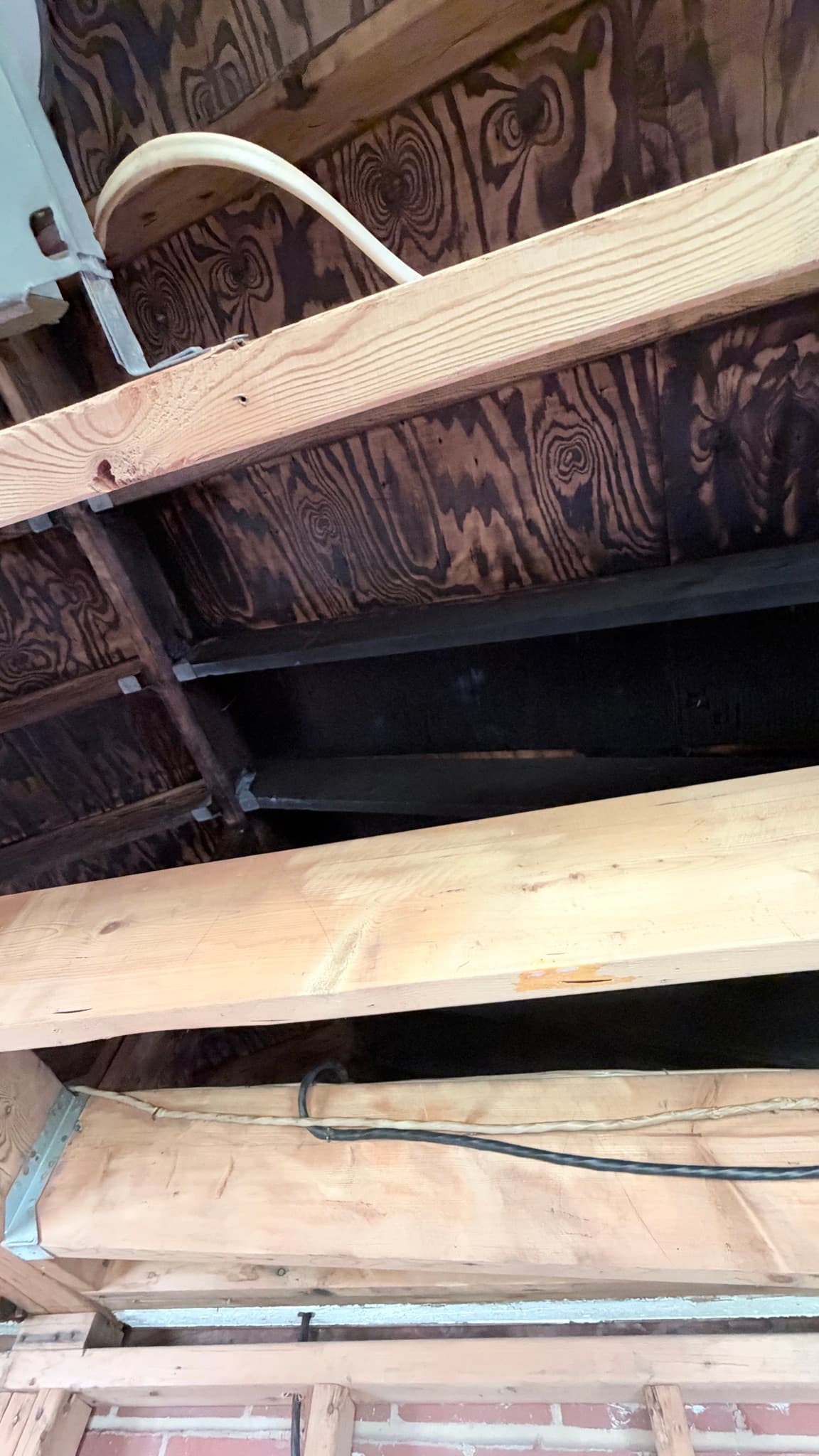 Charred roof sheathing over the kitchen addition