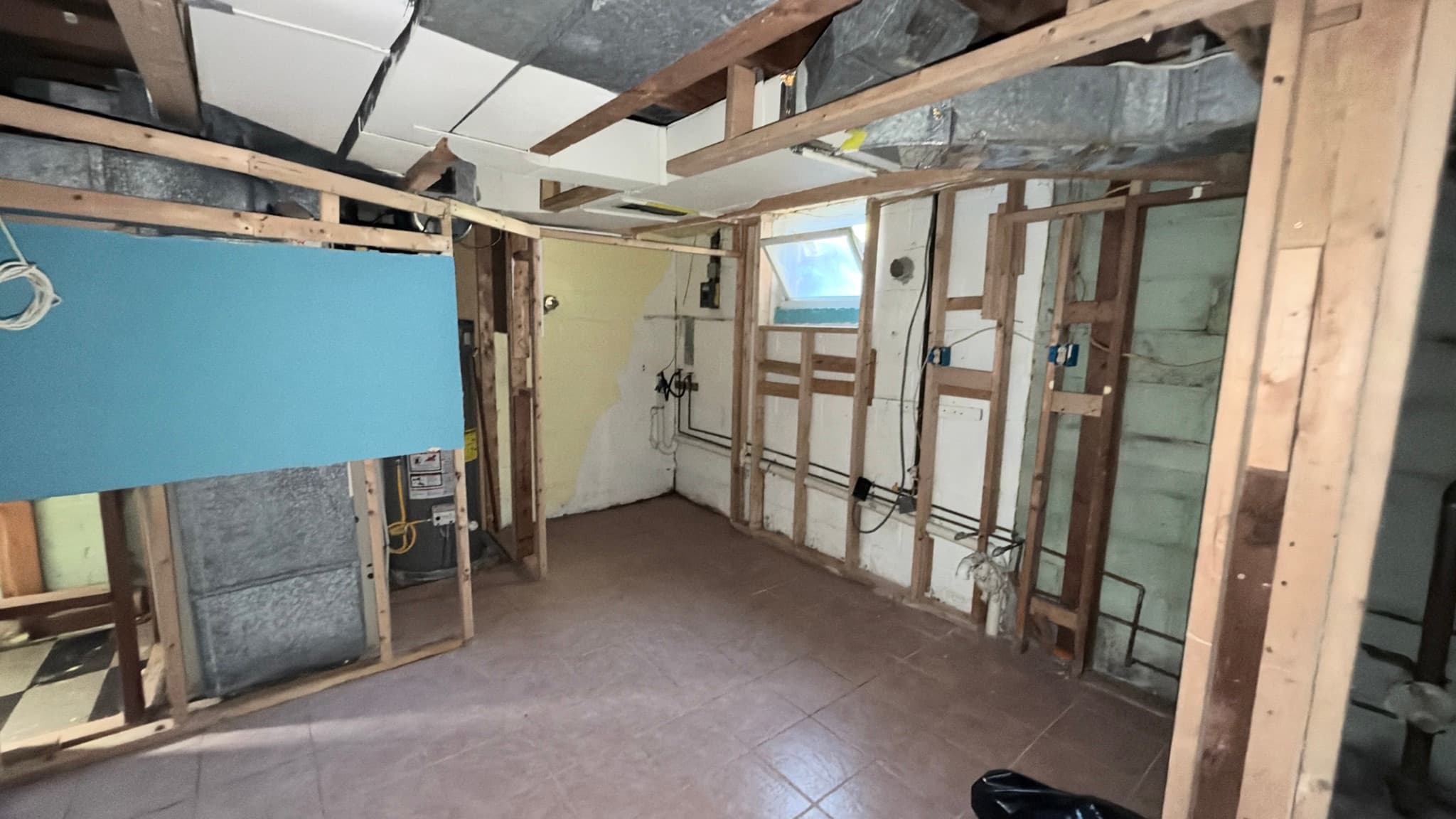 Lower-level utility area — ductwork and plumbing