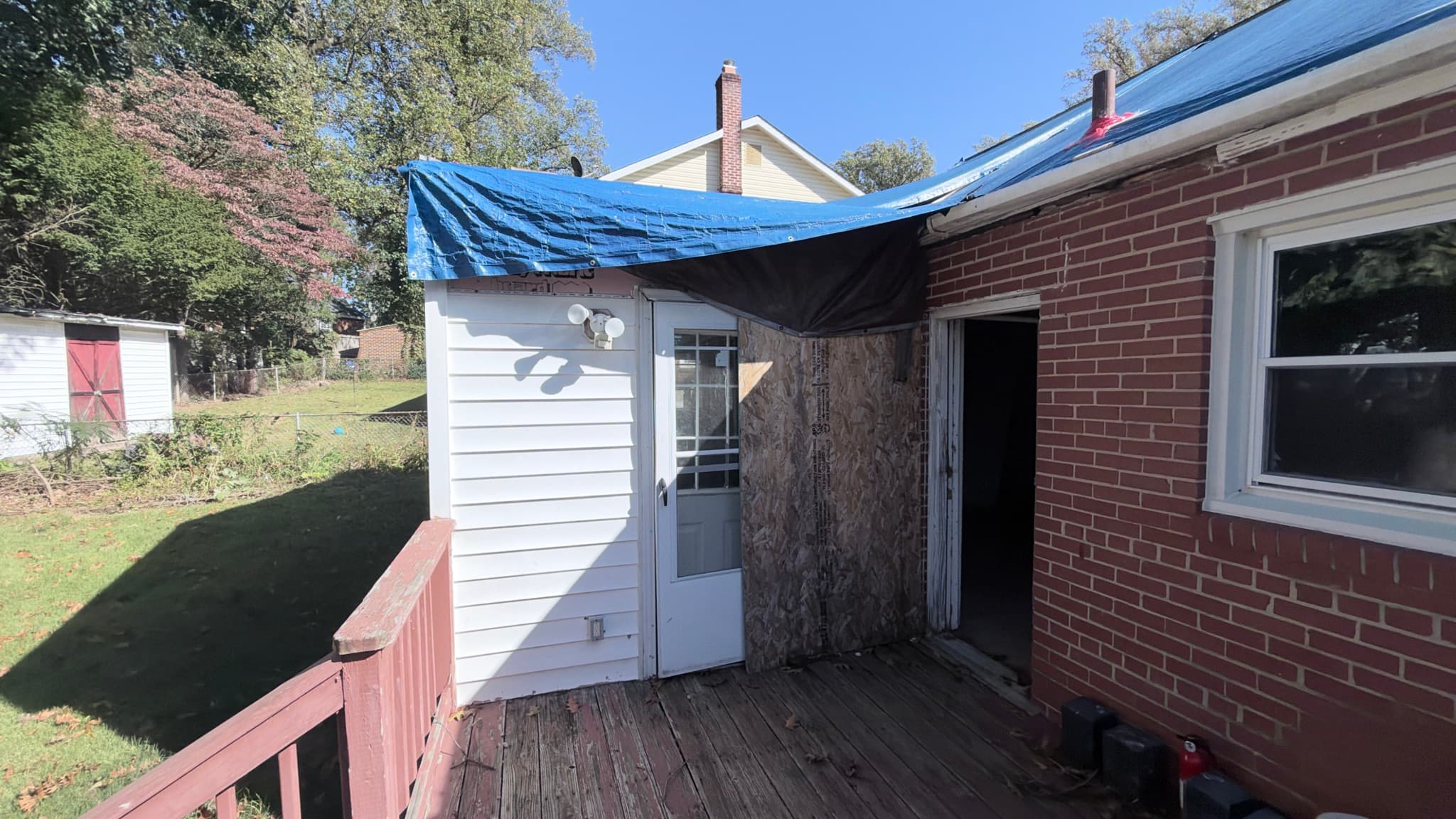 Rear of the kitchen addition and deck — roof currently tarped