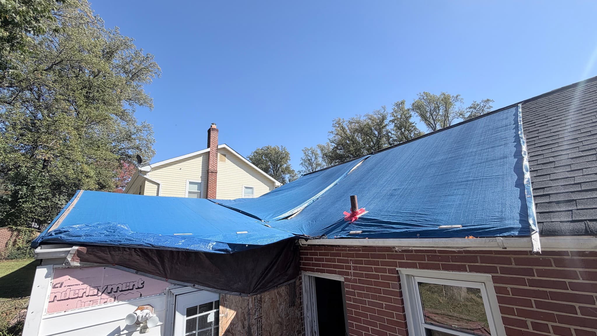 Tarp over the kitchen-addition roof and part of the main roof