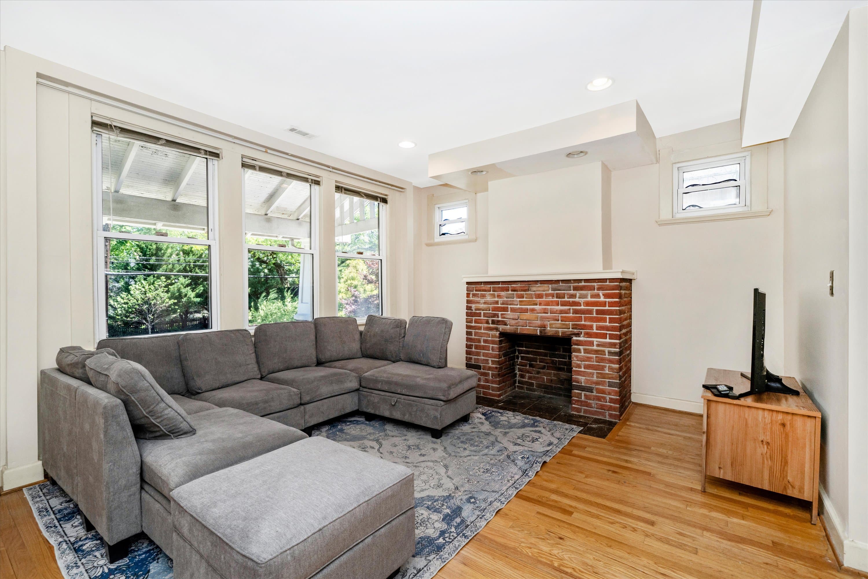 Living room with brick fireplace mantel and hardwood floors at 3034 South Dakota Ave NE