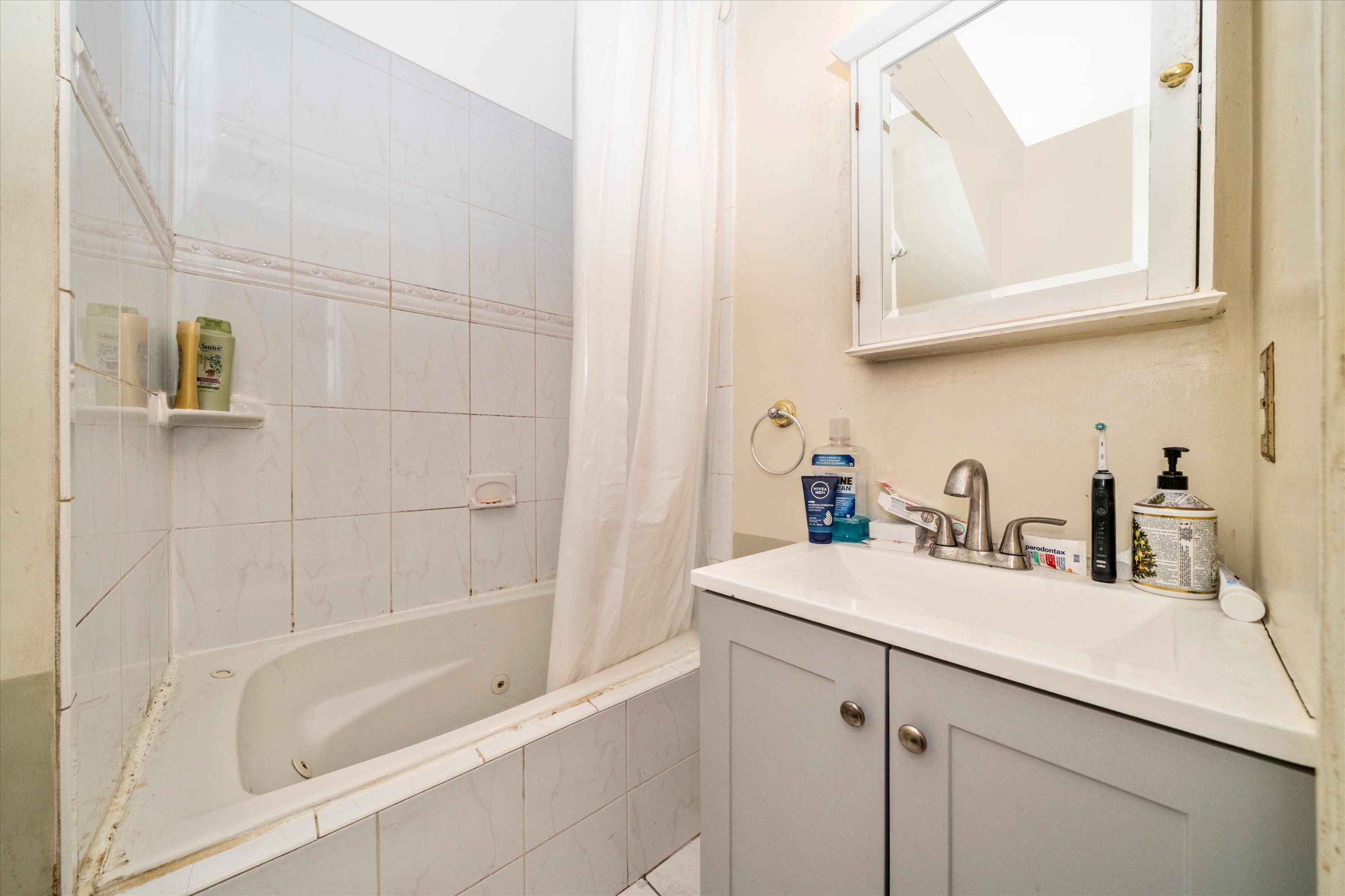 Primary bath with soaking tub and vanity at 3034 South Dakota Ave NE