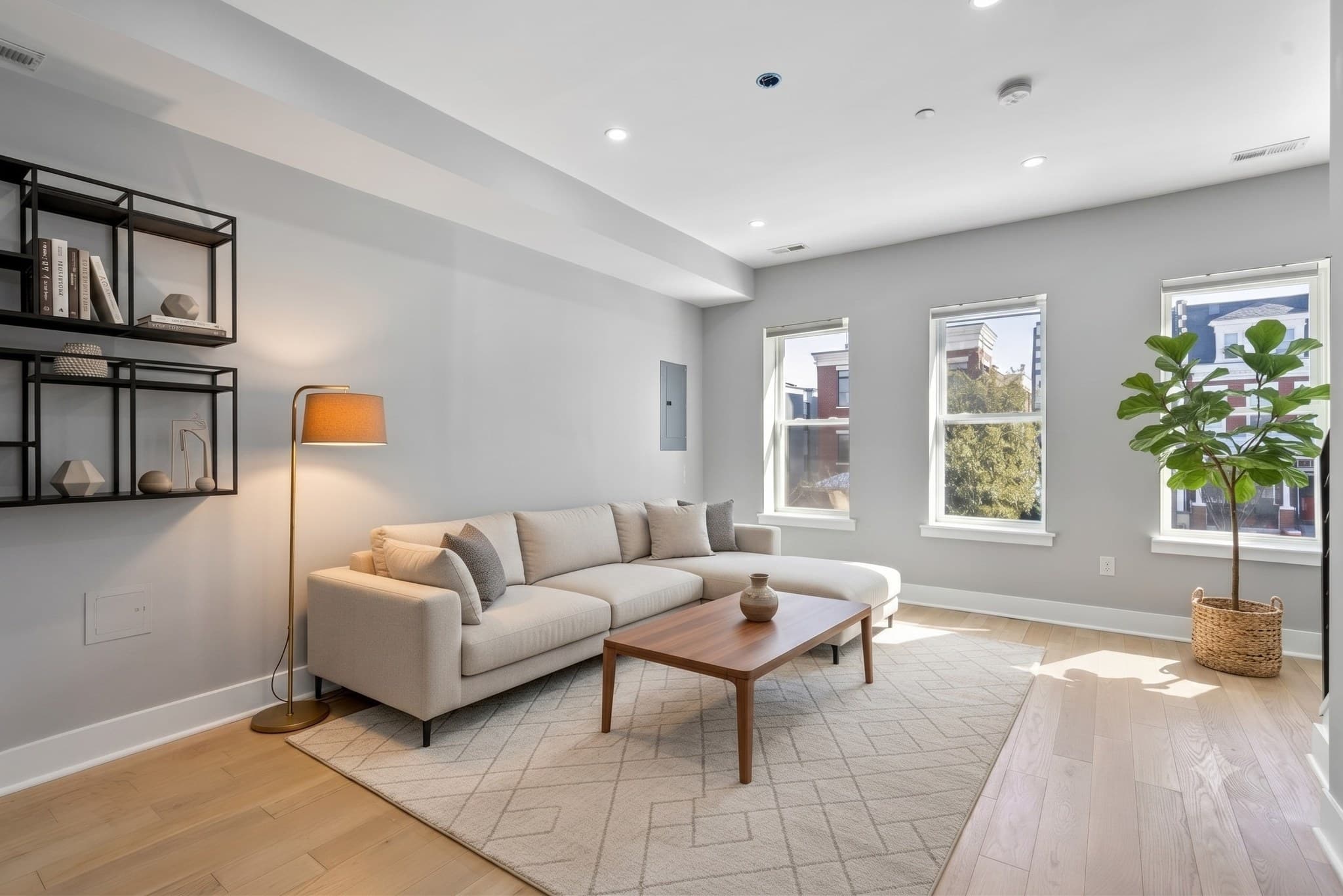 Sun-filled living room with engineered hardwood floors, virtually staged, at 3572 13th St NW #2