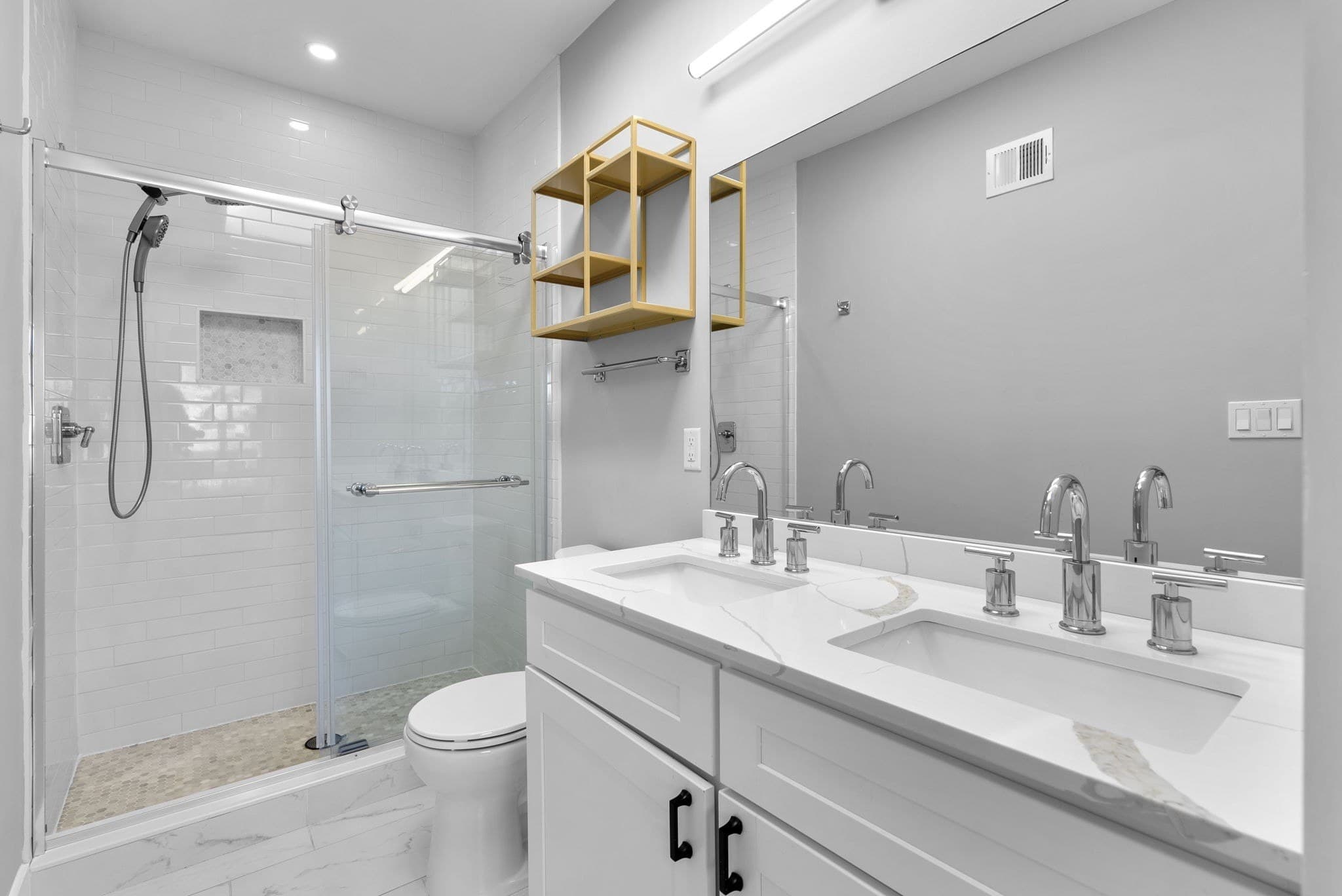 Spa-inspired primary bath with double vanity, walk-in shower, and skylight at 3572 13th St NW #2