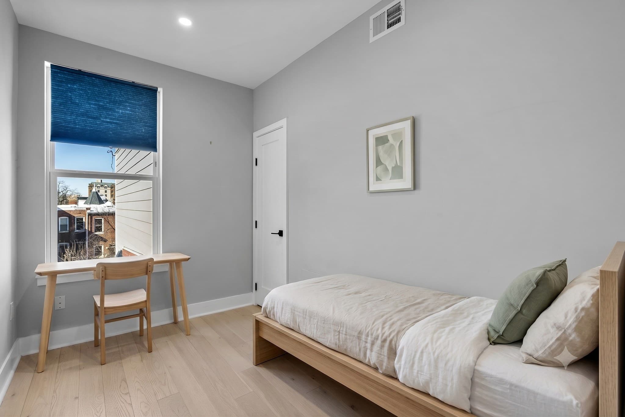 Third bedroom with desk workspace, virtually staged, at 3572 13th St NW #2