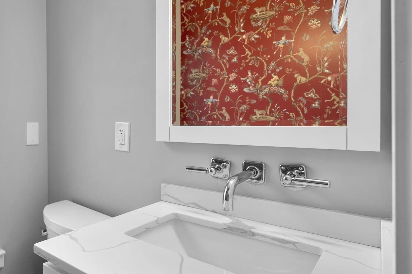 Main level powder room with chinoiserie wallpaper at 3572 13th St NW #2